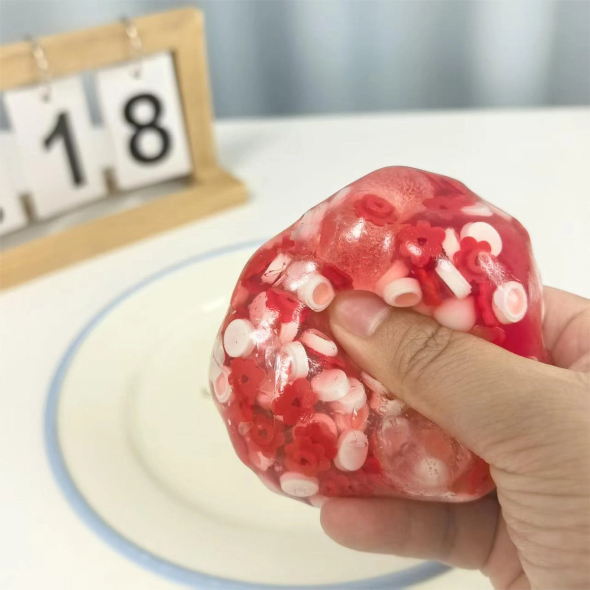 Squeezing the Strawberry Mochi Bloom stress ball