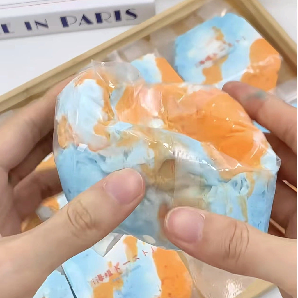 Squeezing the Orange Sea bag with both hands showing texture and flexibility